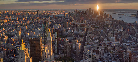 Downtown Manhattan sunset with Freedom Tower as beacon